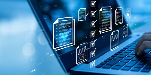 Person typing on a laptop with digital document and checklist icons, representing managed network security services in Central Ontario