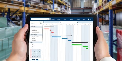 Project planning software for modish business project management on the computer screen showing timeline chart of the team project