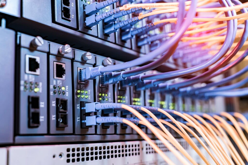 Colorful network cables connected to server racks in a data center, representing a server room infrastructure upgrade case study