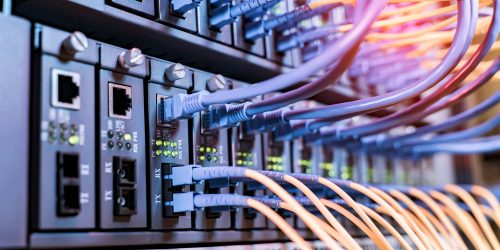 Colorful network cables connected to server racks in a data center, representing a server room infrastructure upgrade case study