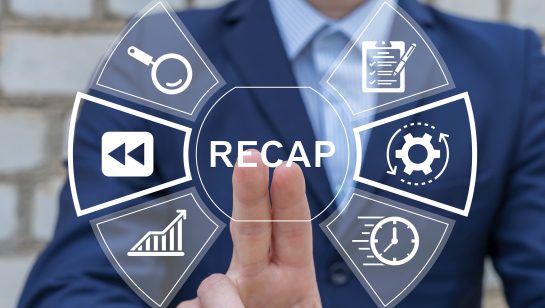 Businessperson touching a virtual interface with icons and the word ‘Recap’ displayed at the center.