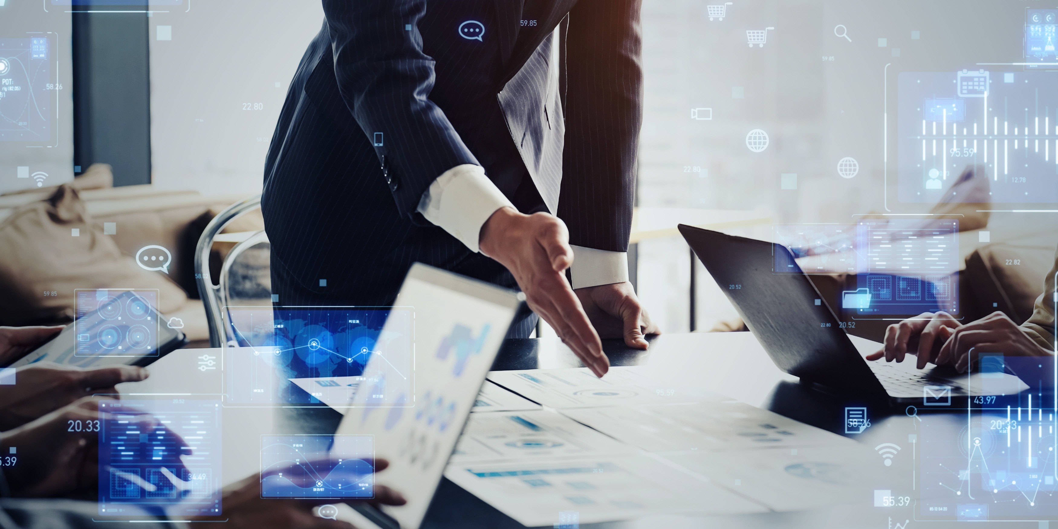 A gentleman reaching over a table of computers