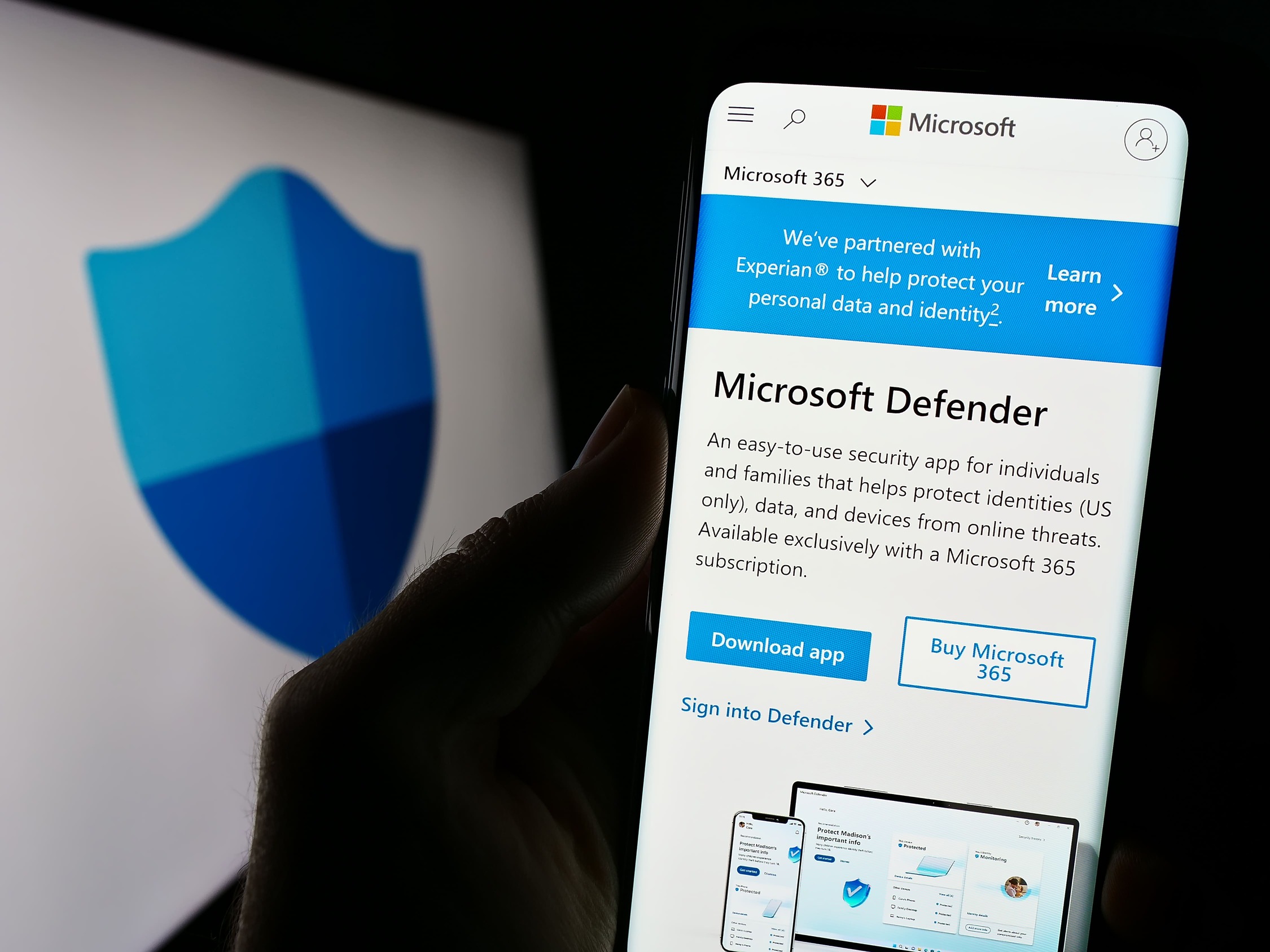 Smartphone screen displaying Microsoft Defender app page with security shield logo in background