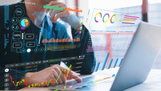 Business professional analyzing digital data dashboards and performance charts on a laptop screen