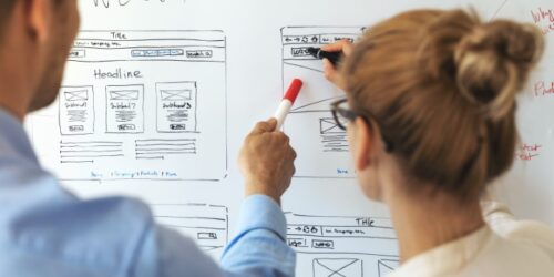UI UX designers team working on new website wireframe in office