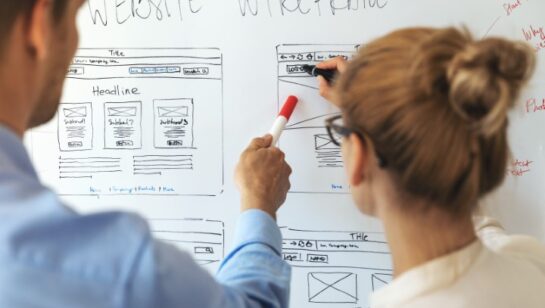 UI UX designers team working on new website wireframe in office