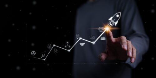 Startup business and investment concept. Businessman is touching the growing business graph. Planning and starting corporate business start up, Rocket icon soars with speed to hit the growth target.