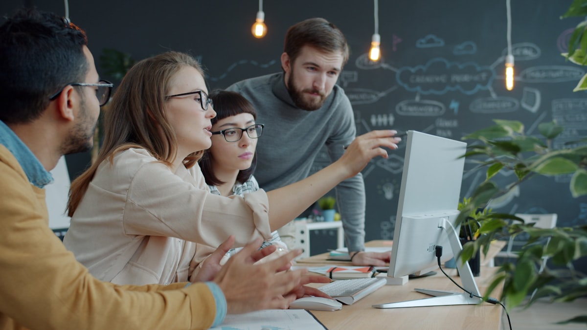 Team collaborating in an office representing human-layer security awareness and compliance support