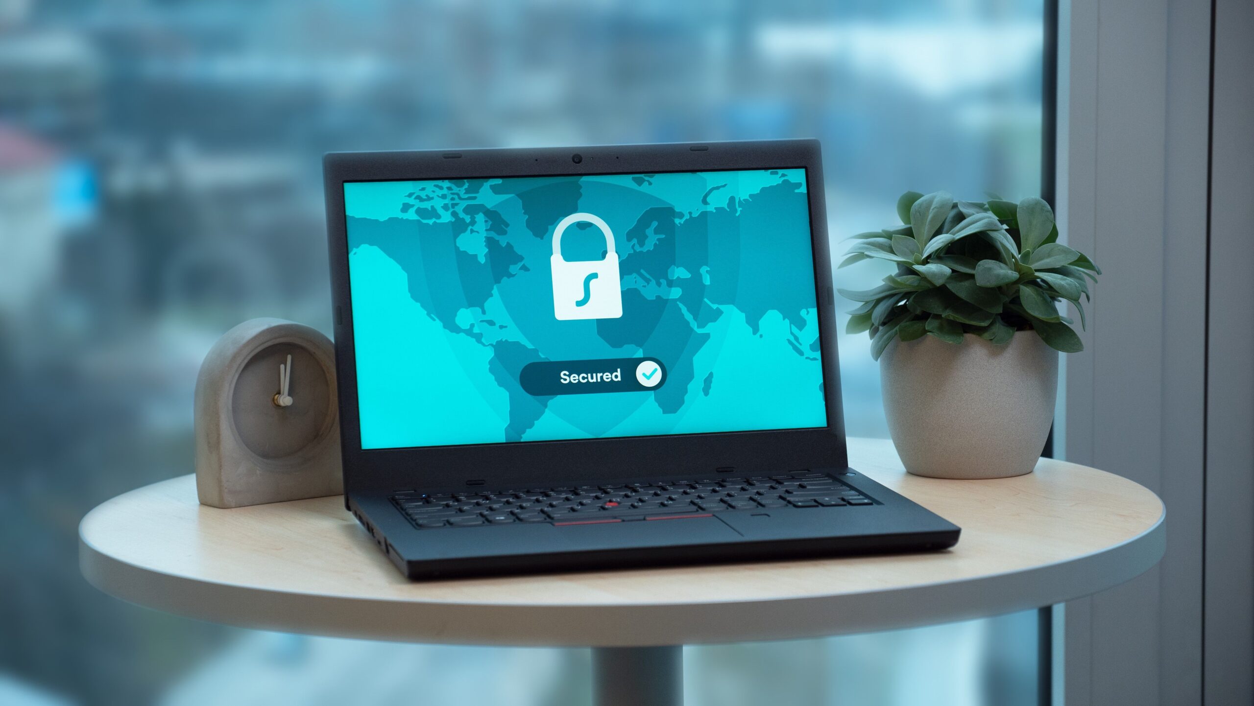 Laptop screen displaying a digital security lock icon representing cybersecurity fundamentals