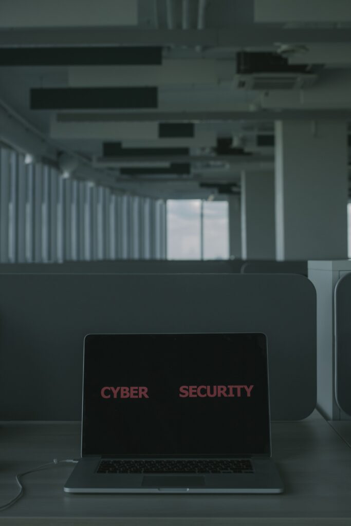 Laptop displaying cybersecurity text in a modern office setting
