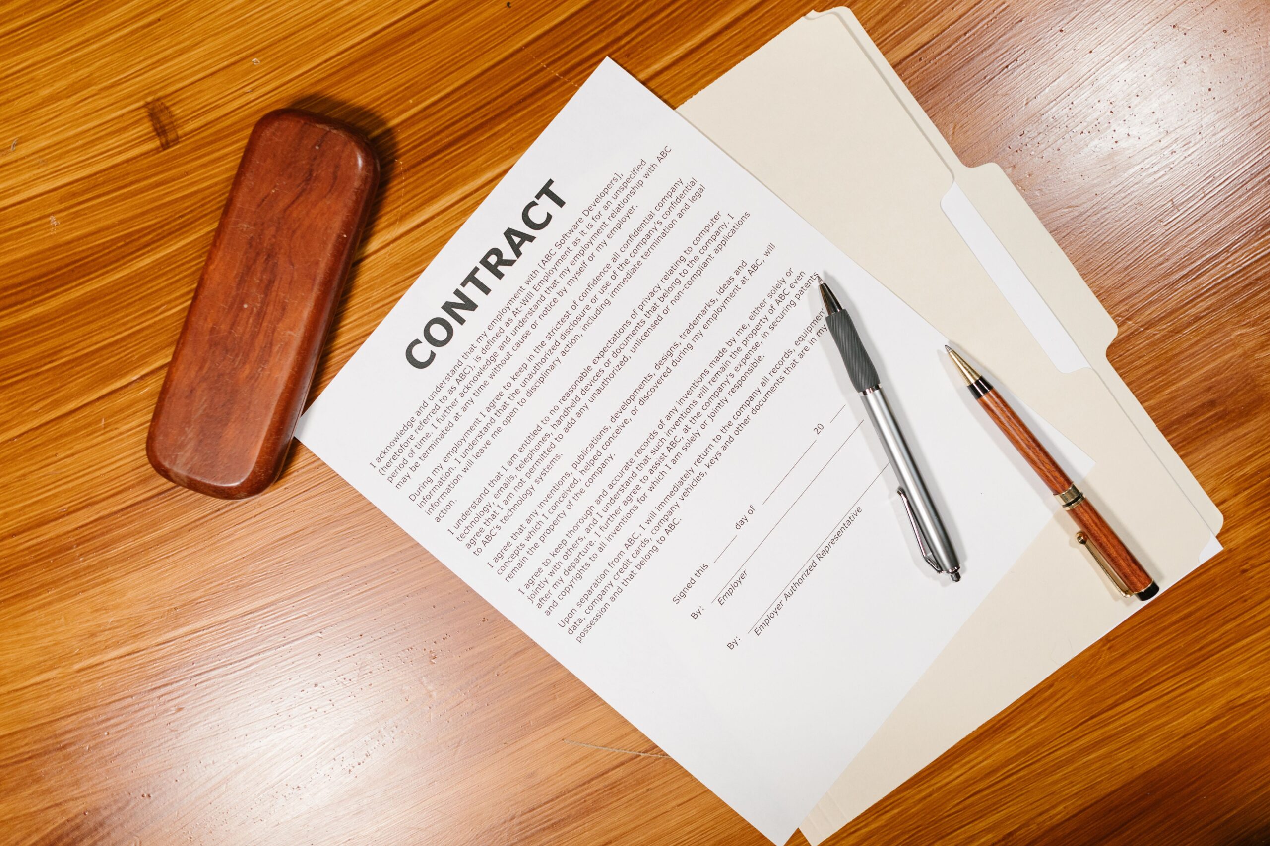 Business contract document with pens on a desk representing vendor and license management