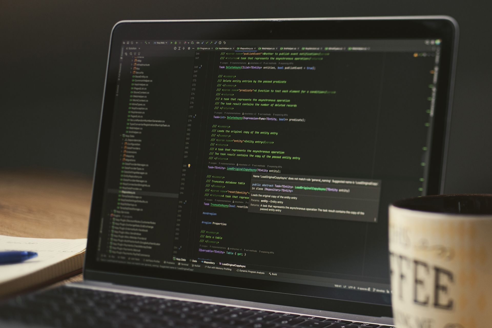 Laptop screen showing code during a late-night coding session, representing the custom reply portal built on the Autotask API