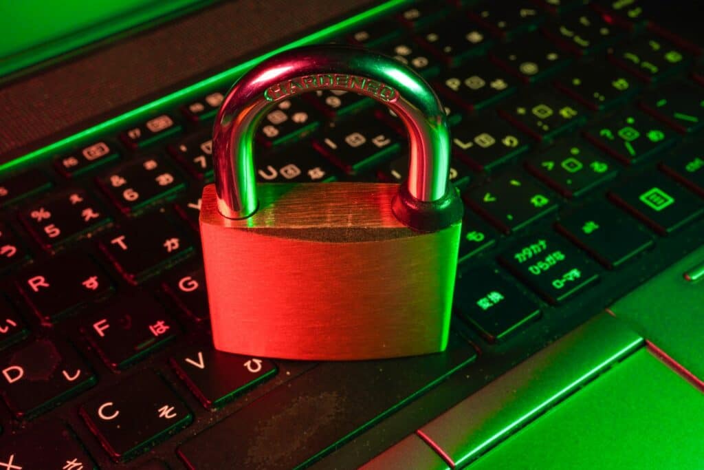Red padlock resting on a computer keyboard, representing security due diligence when evaluating an IT provider