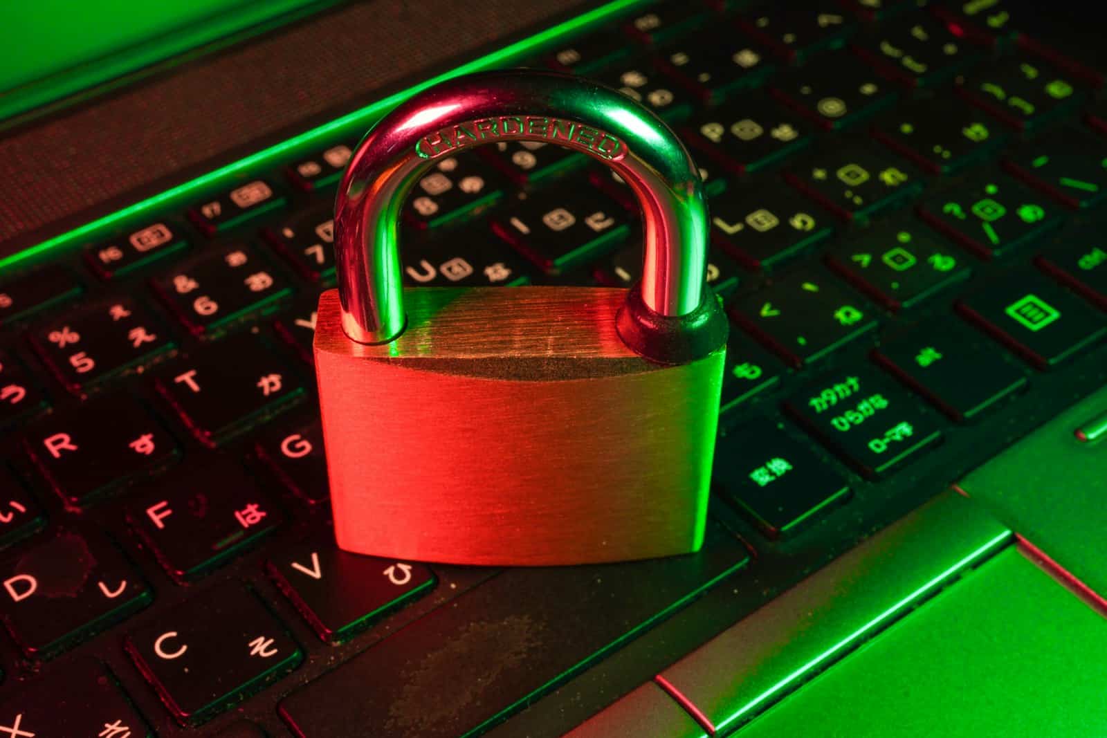 Red padlock resting on a computer keyboard, representing security due diligence when evaluating an IT provider