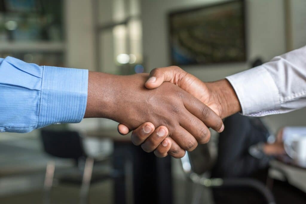 Two people shaking hands, representing a genuine technology partnership