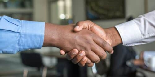 Two people shaking hands, representing a genuine technology partnership