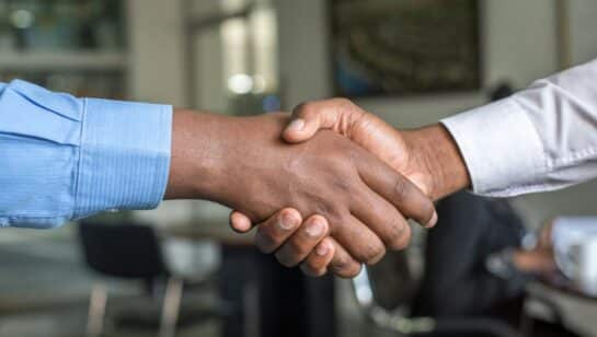 Two people shaking hands, representing a genuine technology partnership