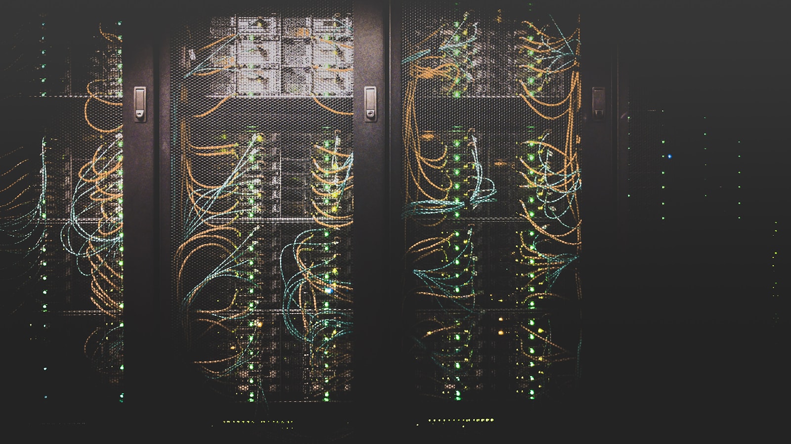 Network cables connected in a server environment, representing security baseline deployment during IT onboarding