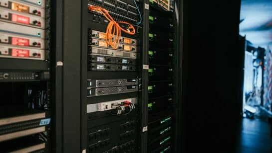 Server rack in a server room, representing systems covered by remote IT monitoring