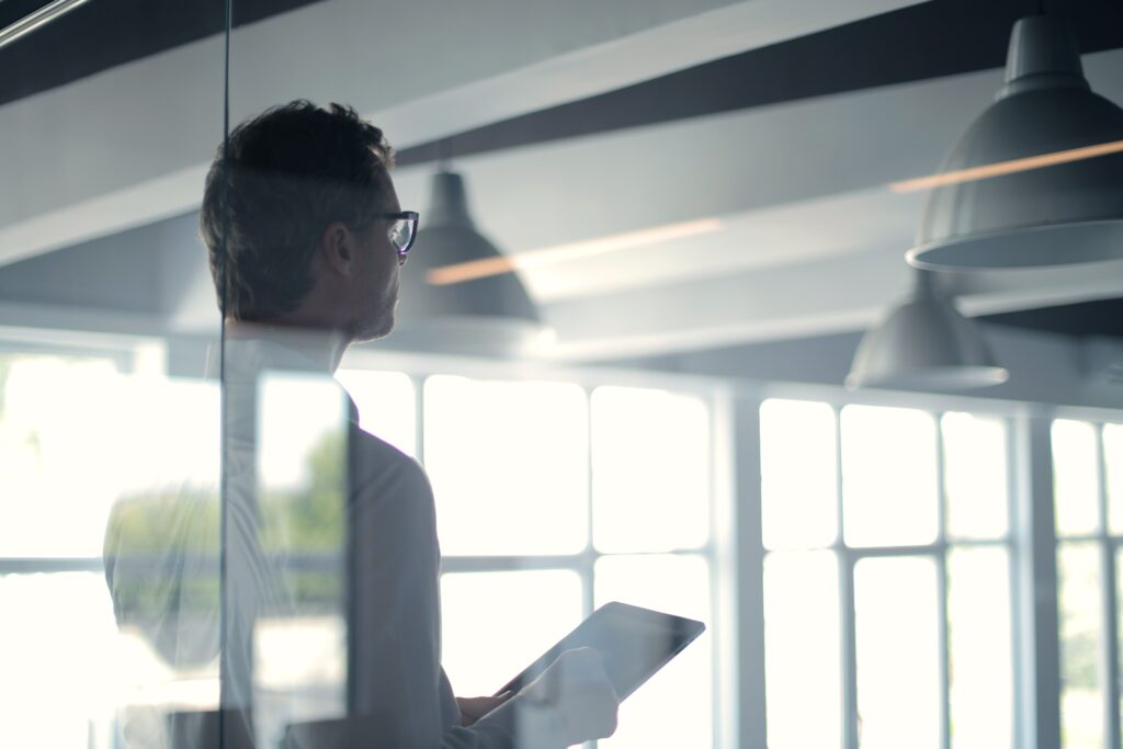 Business professional reviewing a tablet in a modern office