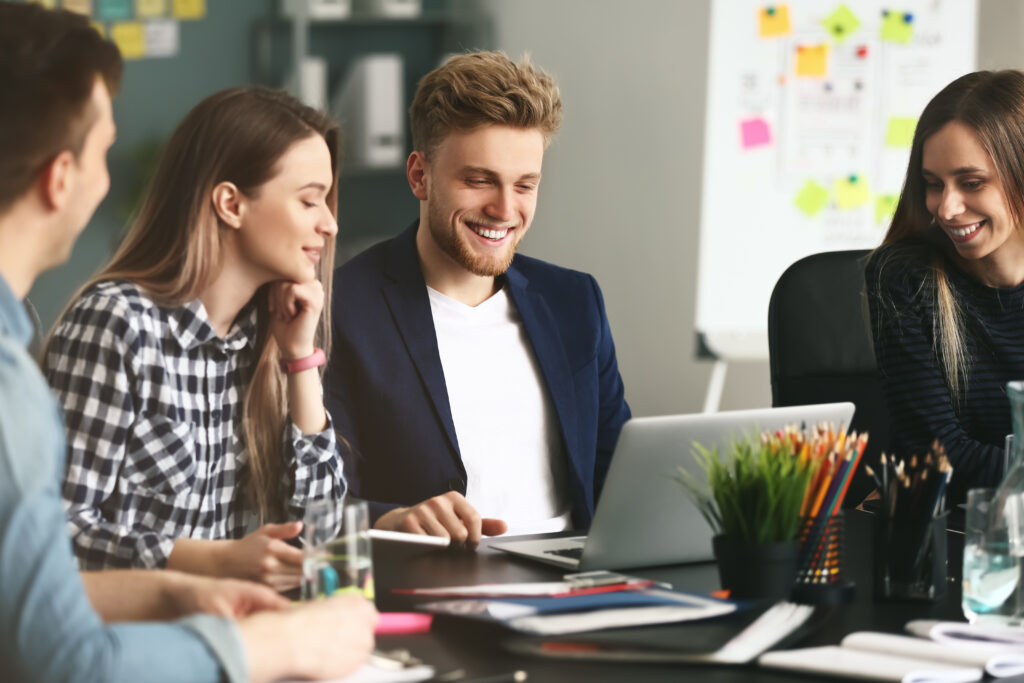 Internal IT staff and an outside IT partner working through a project together at an office table