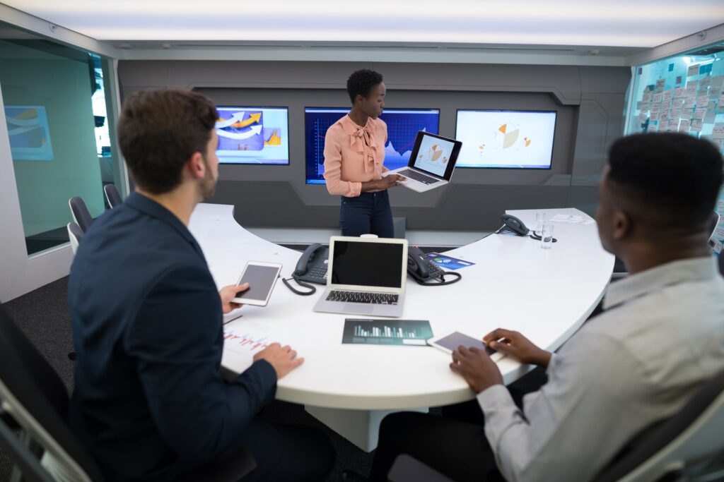 Technology leader briefing a business leadership team on IT strategy in a meeting room