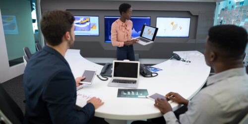 Technology leader briefing a business leadership team on IT strategy in a meeting room