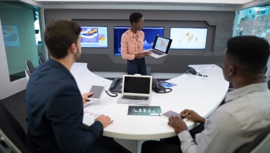 Technology leader briefing a business leadership team on IT strategy in a meeting room