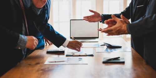 Business professionals meeting to discuss and plan strategy, representing the discovery conversation during an IT assessment