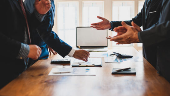 Business professionals meeting to discuss and plan strategy, representing the discovery conversation during an IT assessment