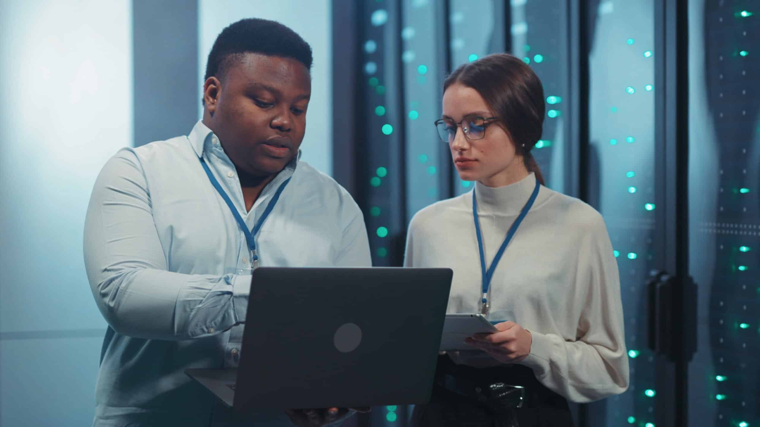 IT administrator and technician managing server infrastructure, representing ACT360 managed IT services