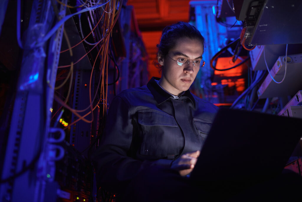 Network technician setting up equipment in a server room during a specialized infrastructure project