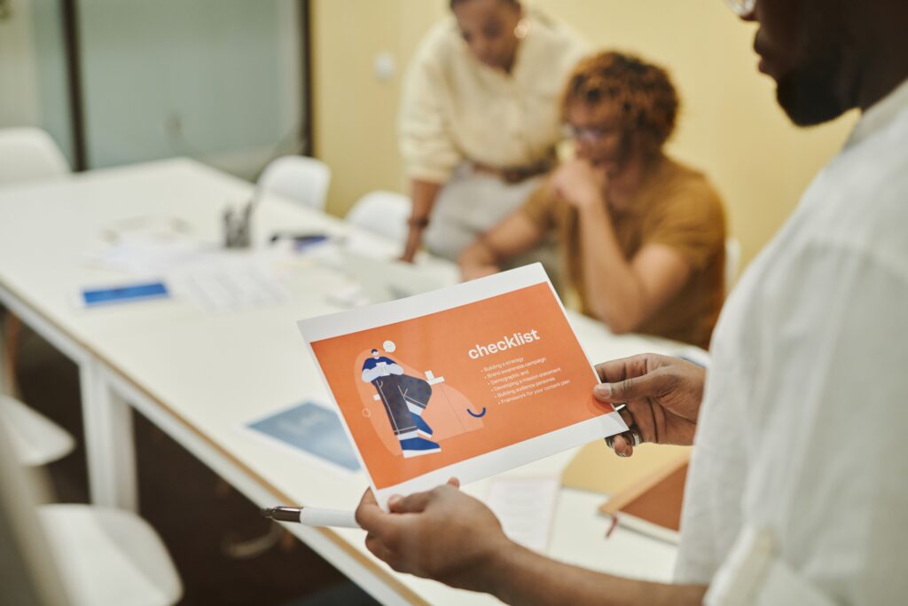 Small business team reviewing a process checklist together in a meeting before deciding what to automate