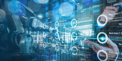 An engineer monitoring automation and robotics on a digital interface in a manufacturing facility, representing the industrial systems targeted by ransomware