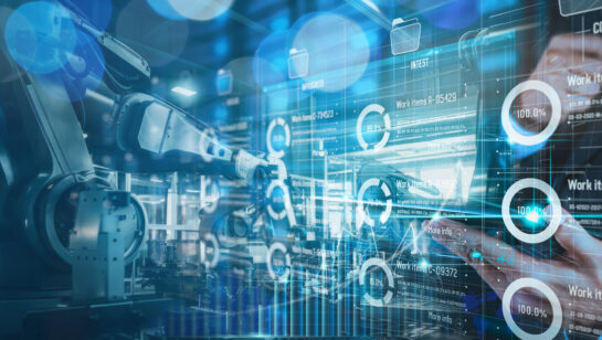 An engineer monitoring automation and robotics on a digital interface in a manufacturing facility, representing the industrial systems targeted by ransomware
