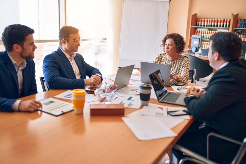 Lawyers and staff meeting around a table at a law firm office, representing small Simcoe County firms choosing an IT support provider