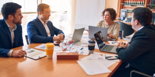 Lawyers and staff meeting around a table at a law firm office, representing small Simcoe County firms choosing an IT support provider