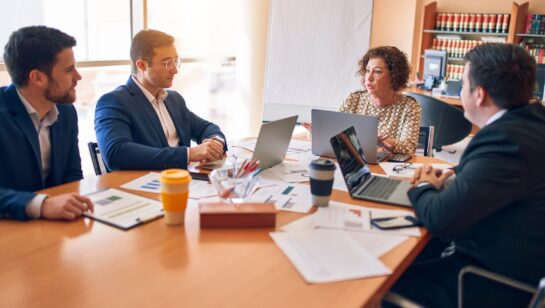 Lawyers and staff meeting around a table at a law firm office, representing small Simcoe County firms choosing an IT support provider