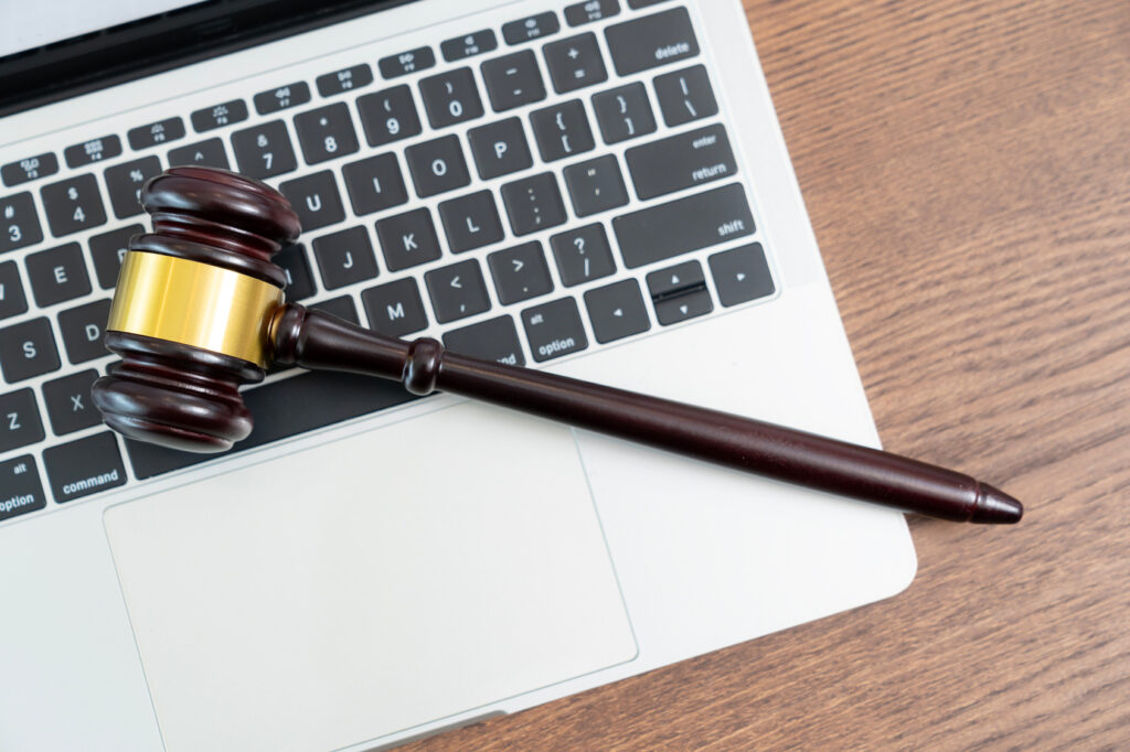Judge's gavel resting on a laptop keyboard, representing cybersecurity for Ontario law firms